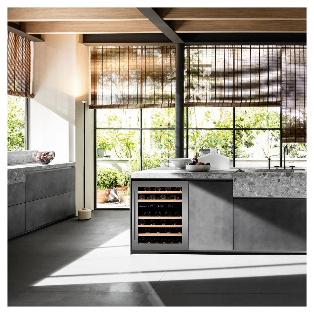 Dunavox Flow-46D Weinkühlschrank als Unterbaugerät in moderner Küche mit Betonarbeitsplatte, Bambusjalousien und Gartenblick
